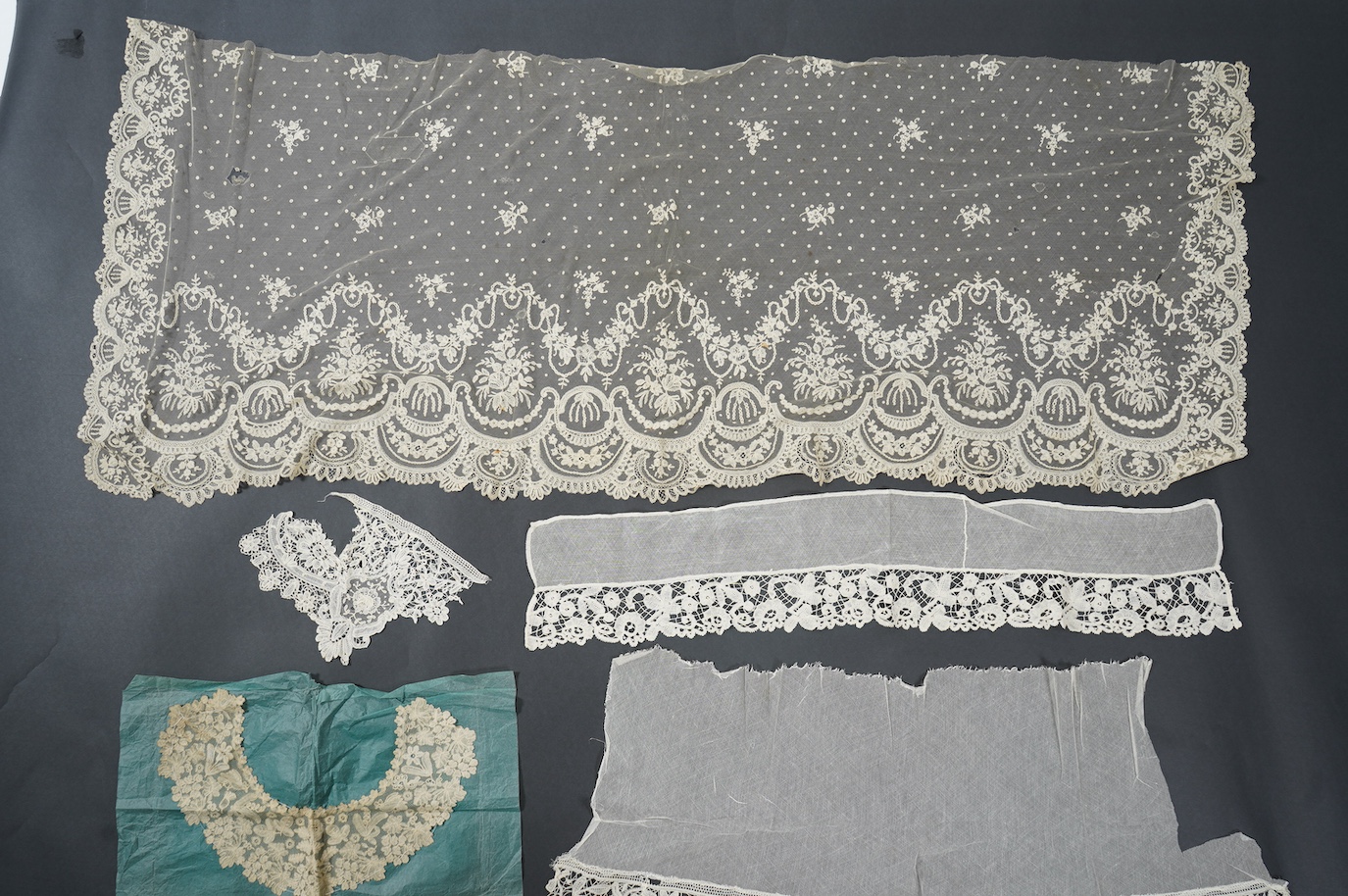 A late 19th century Brussels bobbin lace on net section of a wedding veil, Brussels bobbin lace collar, a point de gaz lace motif and two lengths of later bobbin lace trimming possibly Honiton with needle lace insertions
